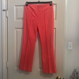 Ladies Coral colored cropped capris. Sewn in crease. Rayon, nylon & spandex